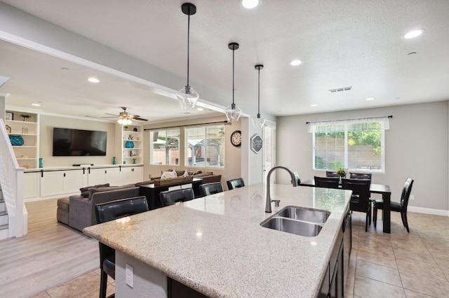 1697 Whiteash Ave, Clovis, CA 93619 - kitchen featuring a sink, plenty of natural light, light stone countertops, and recessed lighting