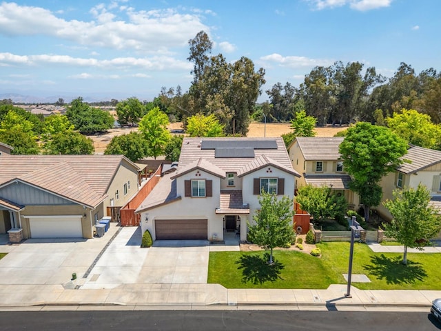 1697 Whiteash Ave, Clovis, CA 93619 - view of front of house featuring concrete driveway, solar panels, stucco siding, a garage, and a tile roof