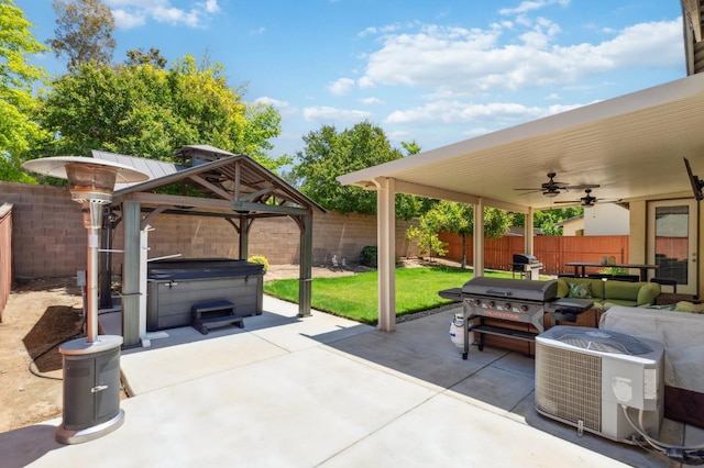 1697 Whiteash Ave, Clovis, CA 93619 - fenced backyard with a hot tub, a gazebo, ceiling fan, a patio area, and a grill