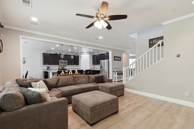 1697 Whiteash Ave, Clovis, CA 93619 - living room featuring stairway, a ceiling fan, light wood-style floors, ornamental molding, and baseboards