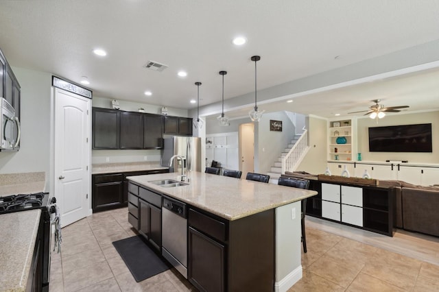 1697 Whiteash Ave, Clovis, CA 93619 - kitchen featuring stainless steel appliances, a sink, open floor plan, light tile patterned flooring, and decorative light fixtures