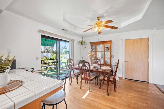 18118 Rd 26, Madera, CA 93638 - dining area with a tray ceiling, a ceiling fan, and light wood-style floors