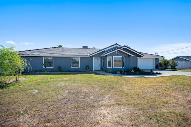 18118 Rd 26, Madera, CA 93638 - ranch-style house featuring concrete driveway, an attached garage, a front yard, and a tiled roof