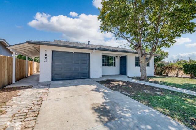 153 Birch, Fresno, CA 93650 - ranch-style house with stucco siding, driveway, a garage, and a carport