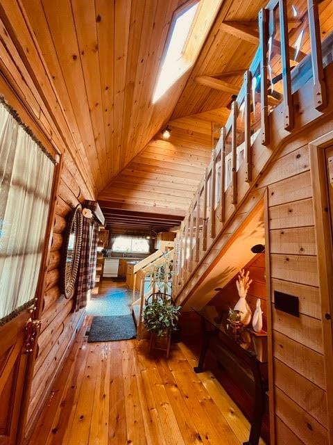 30670 Sentinel Dr, Coarsegold, CA 93614 - interior space featuring wood ceiling, hardwood / wood-style floors, rustic walls, and vaulted ceiling