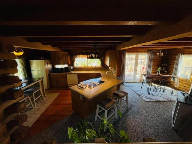 30670 Sentinel Dr, Coarsegold, CA 93614 - kitchen with freestanding refrigerator, wood finished floors, beamed ceiling, a peninsula, and dishwasher