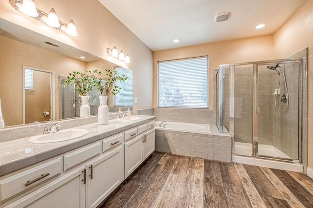 2631 Wrenwood Ave, Clovis, CA 93611 - bathroom with double vanity, wood finished floors, a garden tub, and a stall shower