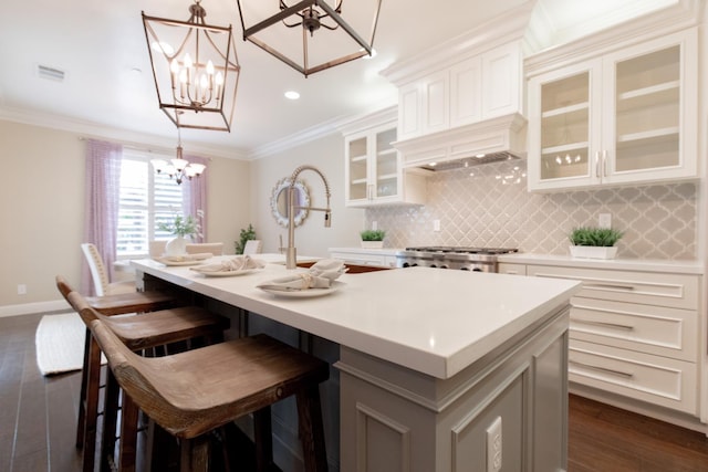 2138 El Paso Ave, Clovis, CA 93611 - kitchen featuring a chandelier, dark wood finished floors, decorative backsplash, light countertops, and range