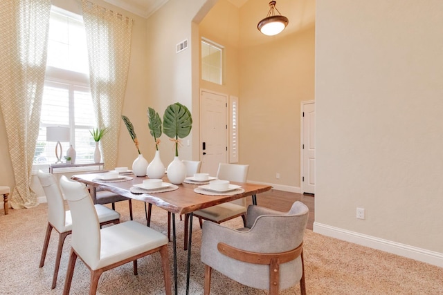 2138 El Paso Ave, Clovis, CA 93611 - carpeted dining space featuring arched walkways, a high ceiling, baseboards, and ornamental molding