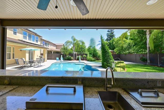 2138 El Paso Ave, Clovis, CA 93611 - view of swimming pool featuring a fenced backyard, a patio area, a sink, and a ceiling fan