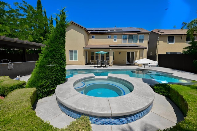 2138 El Paso Ave, Clovis, CA 93611 - rear view of property featuring stucco siding, a patio area, solar panels, and outdoor dining area