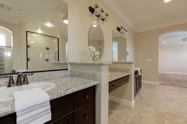 2138 El Paso Ave, Clovis, CA 93611 - bathroom featuring ceiling fan, crown molding, two vanities, tiled shower, and tile patterned floors