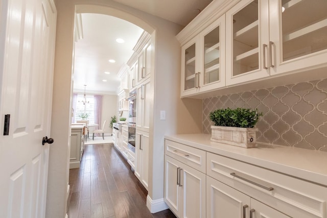 2138 El Paso Ave, Clovis, CA 93611 - bar area featuring arched walkways, dark wood-style floors, recessed lighting, and backsplash