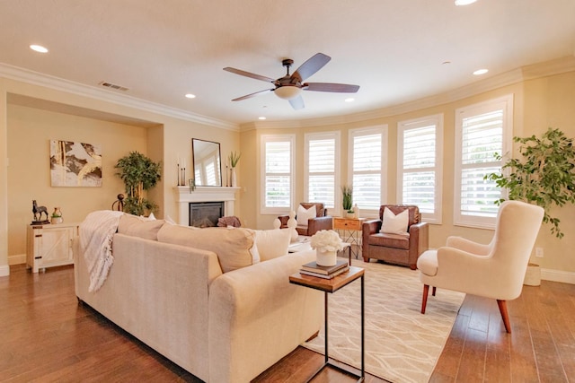 2138 El Paso Ave, Clovis, CA 93611 - living room with wood finished floors, baseboards, a ceiling fan, a glass covered fireplace, and crown molding