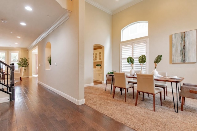 2138 El Paso Ave, Clovis, CA 93611 - dining room featuring arched walkways, wood finished floors, crown molding, baseboards, and recessed lighting