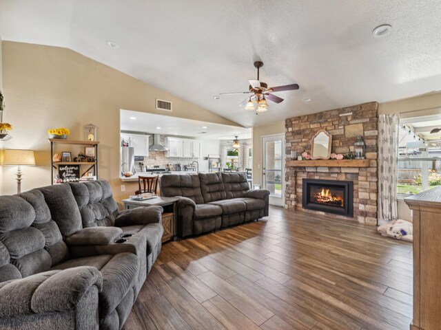 279 Lily Ave, Sanger, CA 93657 - living room featuring vaulted ceiling, ceiling fan, a fireplace, and wood finished floors