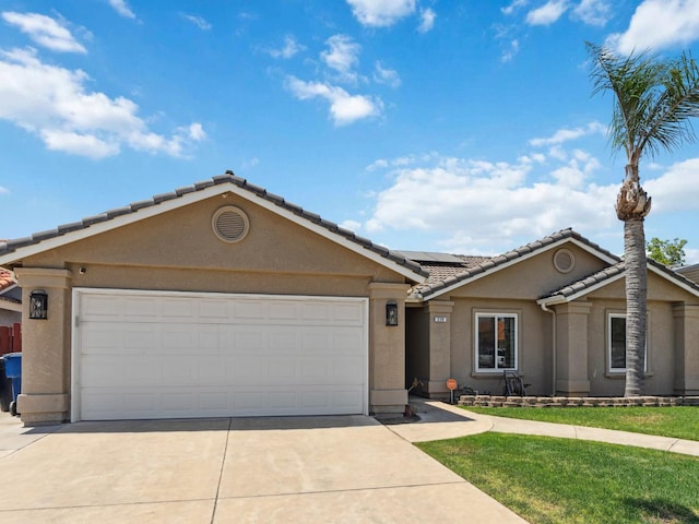 279 Lily Ave, Sanger, CA 93657 - view of front of property with concrete driveway, a tile roof, stucco siding, roof mounted solar panels, and an attached garage