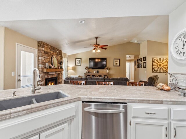 279 Lily Ave, Sanger, CA 93657 - kitchen featuring dishwasher, open floor plan, a sink, a fireplace, and lofted ceiling