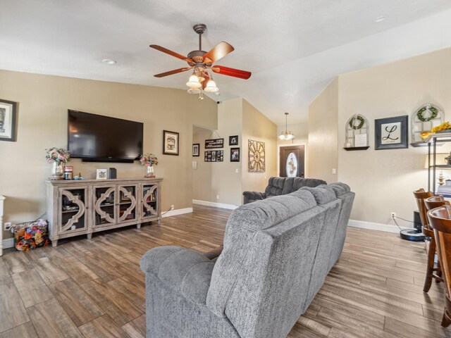 279 Lily Ave, Sanger, CA 93657 - living room with lofted ceiling, ceiling fan, baseboards, and wood finished floors