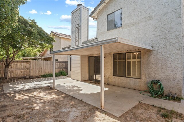 473 E Alluvial Ave Unit 107, Fresno, CA 93720 - back of house with stucco siding, a patio area, and a chimney