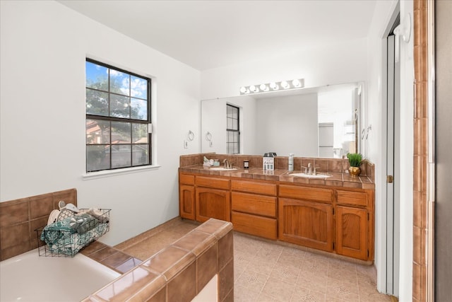 473 E Alluvial Ave Unit 107, Fresno, CA 93720 - bathroom featuring double vanity, a garden tub, and tile patterned flooring