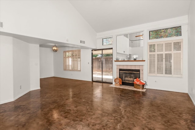 473 E Alluvial Ave Unit 107, Fresno, CA 93720 - unfurnished living room with high vaulted ceiling, a tile fireplace, concrete flooring, and baseboards