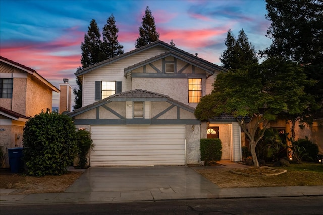 473 E Alluvial Ave Unit 107, Fresno, CA 93720 - view of front of home with a garage, stucco siding, and concrete driveway