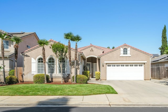 1752 Magnolia, Clovis, CA 93619 - mediterranean / spanish home with stucco siding, an attached garage, concrete driveway, and a tile roof