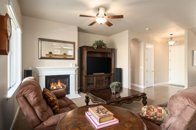 1752 Magnolia, Clovis, CA 93619 - living room featuring ceiling fan, arched walkways, baseboards, and a glass covered fireplace