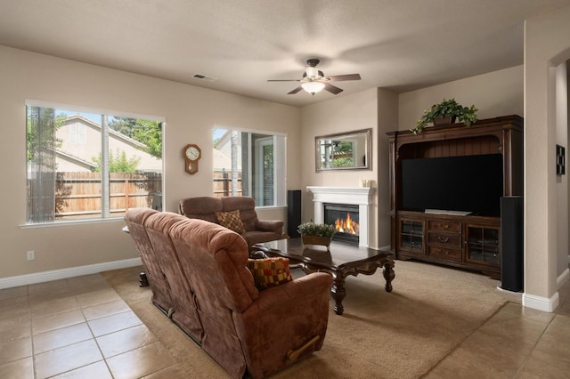 1752 Magnolia, Clovis, CA 93619 - living room featuring tile patterned flooring, a ceiling fan, a glass covered fireplace, and baseboards