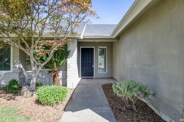 8259 N College Ave, Fresno, CA 93711 - property entrance with brick siding and a shingled roof