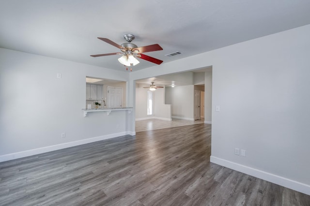 8259 N College Ave, Fresno, CA 93711 - unfurnished living room with ceiling fan, baseboards, and wood finished floors