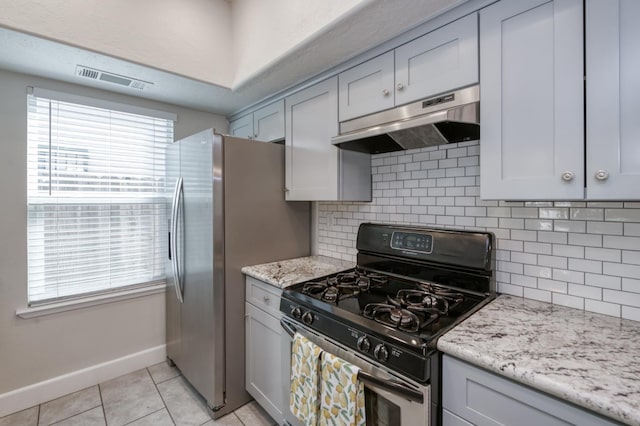 8259 N College Ave, Fresno, CA 93711 - kitchen with stainless steel appliances, under cabinet range hood, baseboards, light tile patterned flooring, and tasteful backsplash