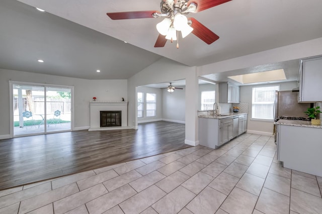 8259 N College Ave, Fresno, CA 93711 - kitchen featuring stainless steel dishwasher, a ceiling fan, a sink, recessed lighting, and baseboards