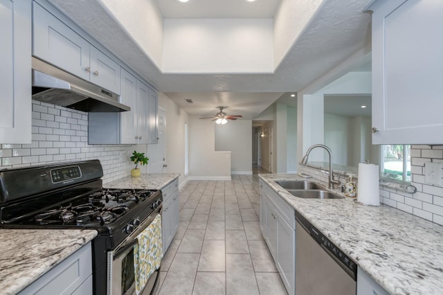 8259 N College Ave, Fresno, CA 93711 - kitchen featuring range with gas stovetop, under cabinet range hood, a sink, stainless steel dishwasher, and tasteful backsplash