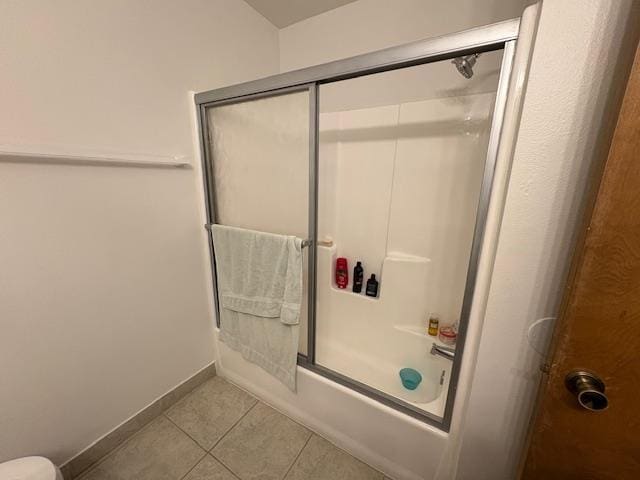 2407 W Carmen Ave, Fresno, CA 93728 - bathroom with shower / bath combination with glass door, tile patterned flooring, baseboards, and toilet