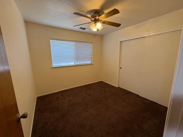 2407 W Carmen Ave, Fresno, CA 93728 - unfurnished bedroom featuring dark carpet, a closet, and ceiling fan