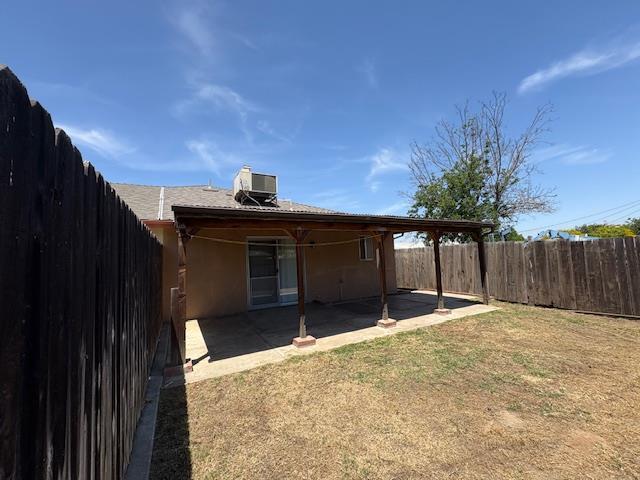 2407 W Carmen Ave, Fresno, CA 93728 - rear view of house with central air condition unit, a patio, and stucco siding