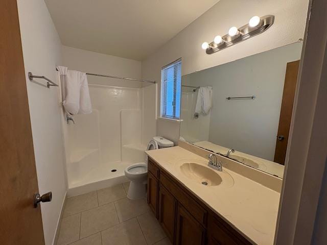 2407 W Carmen Ave, Fresno, CA 93728 - bathroom featuring a shower, toilet, vanity, tile patterned floors, and baseboards