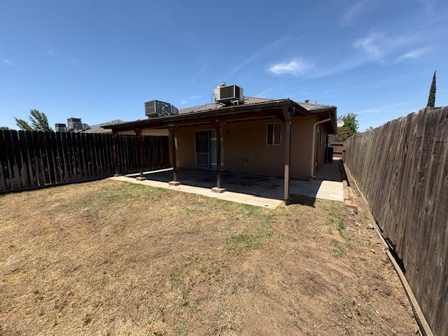 2407 W Carmen Ave, Fresno, CA 93728 - back of house featuring cooling unit, a patio, and stucco siding