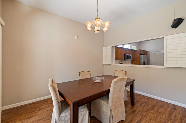 5125 N Via Amore, Fresno, CA 93711 - dining room featuring a chandelier, baseboards, and wood finished floors
