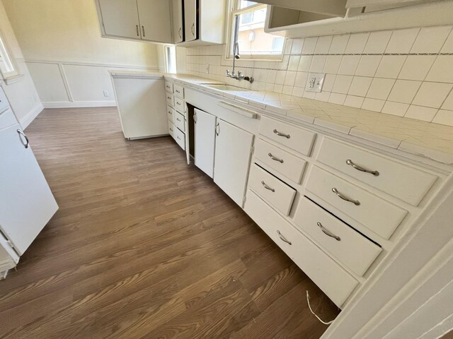 1305 E Fedora Ave, Fresno, CA 93704 - kitchen with dark wood-style flooring, a sink, tile counters, backsplash, and a wainscoted wall