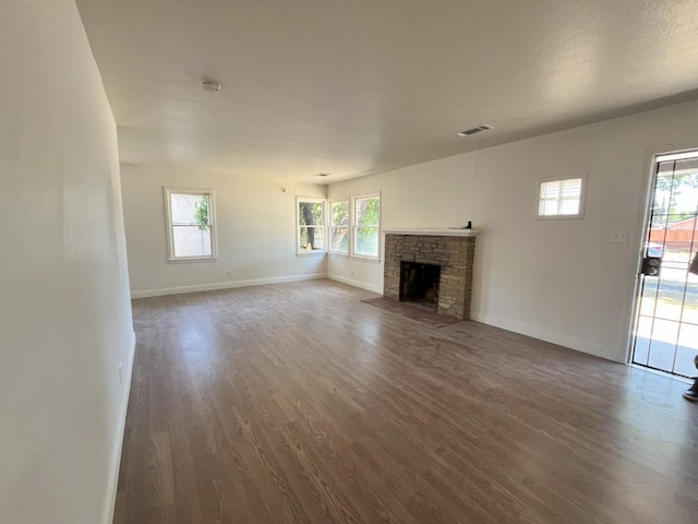 1305 E Fedora Ave, Fresno, CA 93704 - unfurnished living room with dark wood-style flooring, healthy amount of natural light, and a fireplace