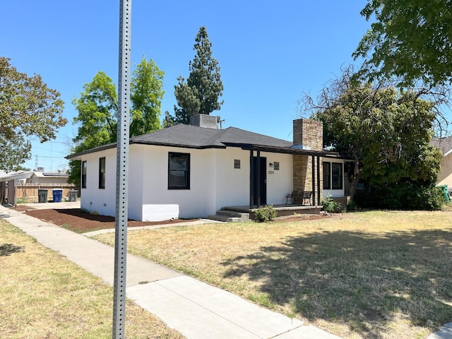 1305 E Fedora Ave, Fresno, CA 93704 - view of front of home with a front lawn, a chimney, and stucco siding