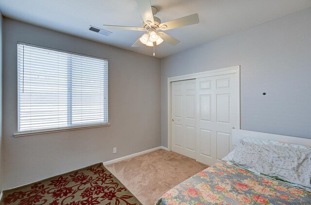 2701 Glade Ave, Madera, CA 93637 - bedroom featuring light colored carpet, a closet, baseboards, and a ceiling fan