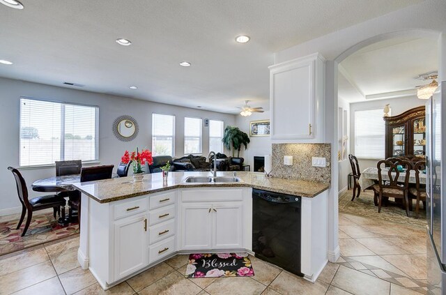2701 Glade Ave, Madera, CA 93637 - kitchen featuring dishwasher, a sink, white cabinetry, light stone countertops, and a peninsula