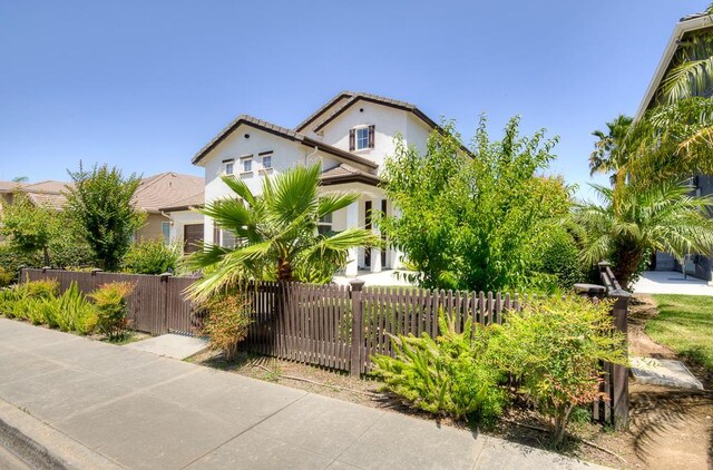 2701 Glade Ave, Madera, CA 93637 - view of front of property with a fenced front yard, stucco siding, and a tiled roof