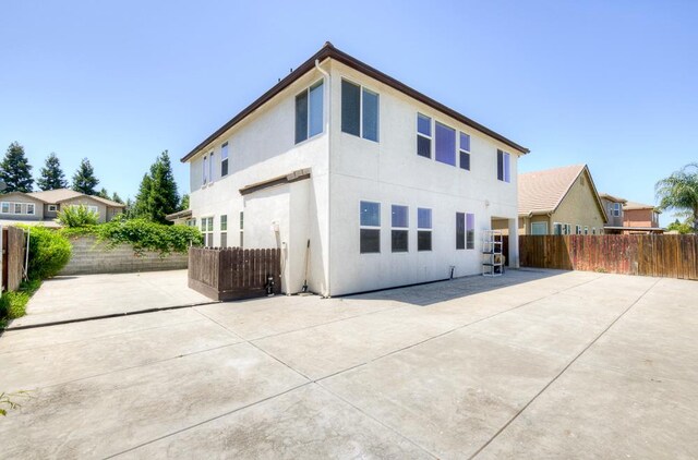 2701 Glade Ave, Madera, CA 93637 - rear view of house featuring a patio area, a fenced backyard, and stucco siding