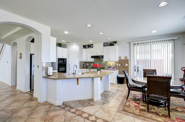 2701 Glade Ave, Madera, CA 93637 - kitchen featuring freestanding refrigerator, a sink, a peninsula, decorative backsplash, and light stone counters