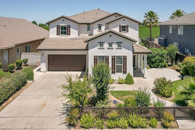 2701 Glade Ave, Madera, CA 93637 - view of front facade featuring an attached garage, driveway, a tiled roof, and stucco siding